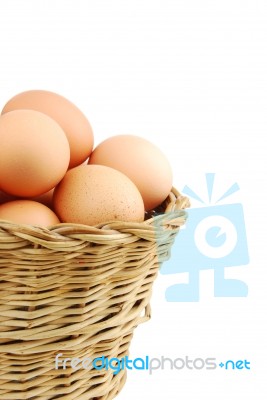 Close-up Of Eggs In A Wicker Basket On White Stock Photo