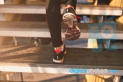 Close Up Of Feet With Sneakers Climbing Up The Stairs Stock Photo