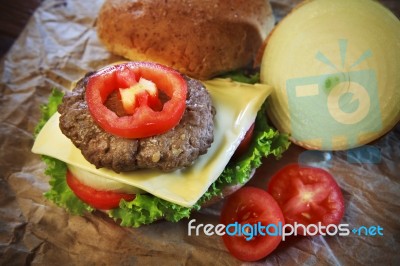 Close Up Of Ham Cheese Burger And Bun With Tomato Onion And Gree… Stock Photo