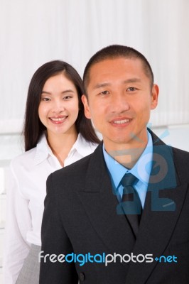 Close-up Of Smiling Businesspeople Stock Photo