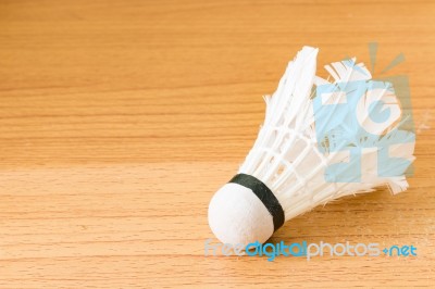 Close Up White Shuttlecock On Wooden Background Stock Photo