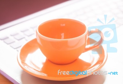 Closeup Coffee Cup On Laptop Stock Photo