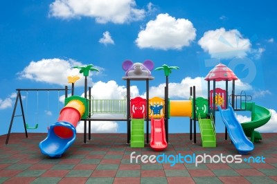 Closeup Colorful Playground With Prevent Injuries Yard In Park On Blue Sky Background Stock Photo