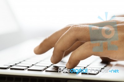 Closeup Hand Typing On Laptop Keyboard Stock Photo