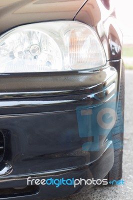Closeup Headlight Of Black Coupe Stock Photo