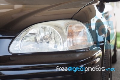 Closeup Headlight Of Black Coupe Stock Photo