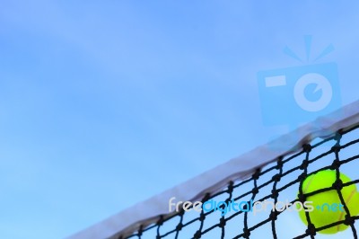 Closeup Tennis Net And Ball With Blue Sky Stock Photo