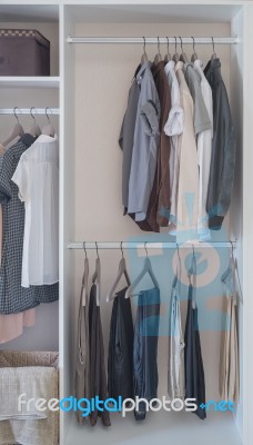 Clothes Hanging In White Wardrobe Stock Photo