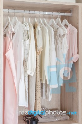 Clothes Hanging In Wooden Wardrobe Stock Photo