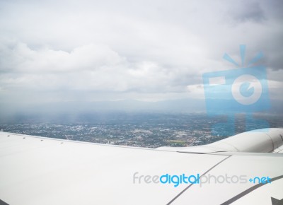 Clouds And Land As Seen Through Window Of An Aircraft Stock Photo