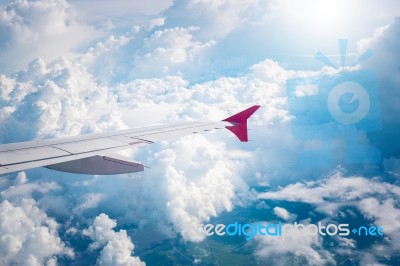 Cloudy Sky And Red Airplane Wing As Seen Through Window On Aircr… Stock Photo