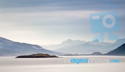 Coast Of  Norway Sea In Clouds Of Haze. Beacon On A Rock Stock Photo