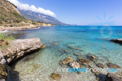 Coast With Blue Sea Rocks And Mountains In Greece Stock Photo