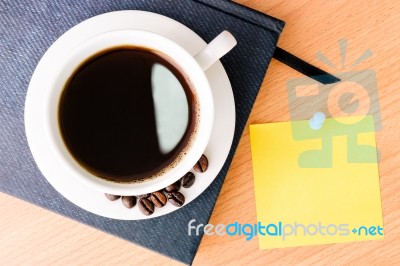 Coffee And Note Pad On Wood Table Stock Photo