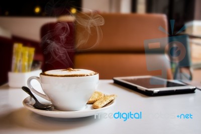 Coffee And Tablet On Table In Cafe Stock Photo