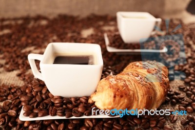 Coffee Beans And Croissant Stock Photo