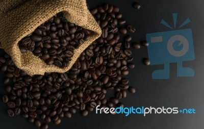 Coffee Beans In Sack On Black Background Stock Photo
