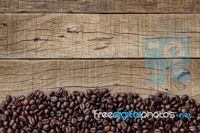 Coffee Beans On Grain Wood Stock Photo