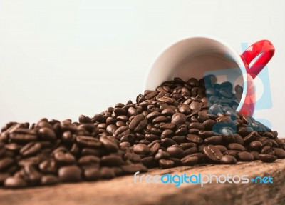 Coffee Cup And Beans On Wood Background Stock Photo