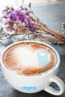 Coffee Cup With Beautiful Violet Flower Stock Photo