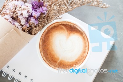 Coffee Cup With Beautiful Violet Flower Stock Photo