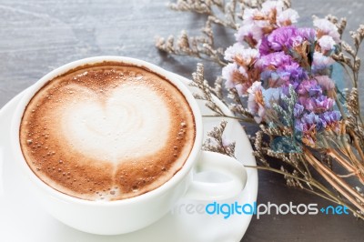 Coffee Cup With Beautiful Violet Flower Stock Photo