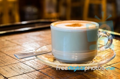 Coffee Cup With Milk Froth On Wooden Chess Table Stock Photo