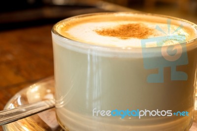 Coffee Cup With Milk Froth On Wooden Table Stock Photo