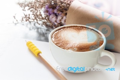 Coffee Cup With Notepad On Grey Background Stock Photo