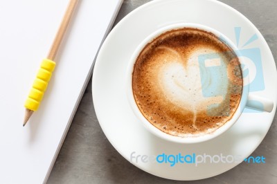 Coffee Cup With Notepad On Grey Background Stock Photo