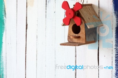 Colorful Bird House On Grunge Wall Stock Photo