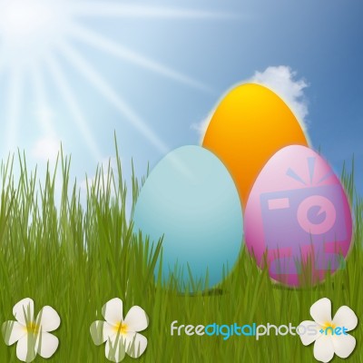 Colorful Easter Eggs Sitting On Grass Field With Blue Sky Background Stock Image