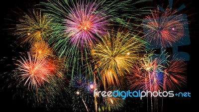 Colorful Firework Celebration On Dark Night Sky Background Stock Photo