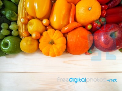 Colorful Fresh Fruits And Vegetables On Wood Background, Healthy… Stock Photo