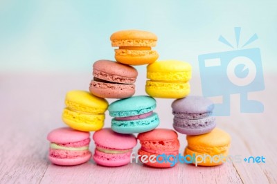 Colorful Macarons On A Pink Wooden Table Stock Photo