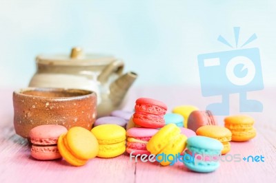 Colorful Macarons On A Pink Wooden Table Stock Photo
