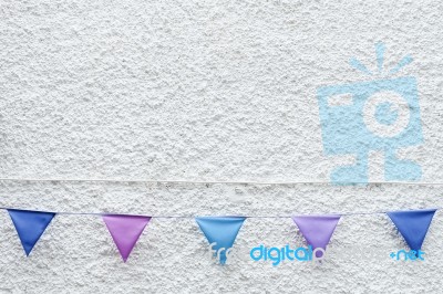 Colorful Party Flags Bunting Hanging On White Wall Background. Minimal Hipster Style Design Stock Photo