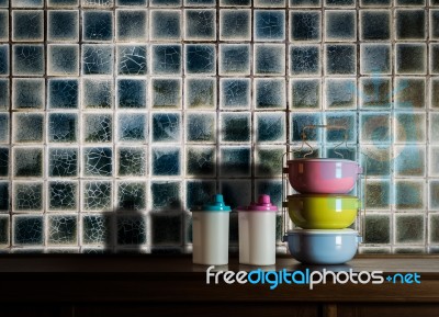Colorful Tiffin Carrier And Plastic Bottles On Wooden Cupboard W… Stock Photo