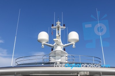 Communication Antennas With Navigation Equipment, Radar On The Upper Deck Of The Luxury White Cruise Ship.  There Is A Thai Flag With Clear Blue Sky In The Sunny Day Stock Photo