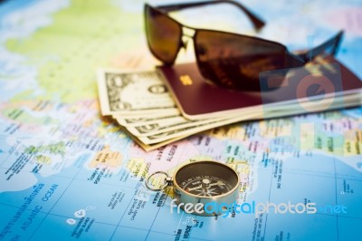 Compass, Passport, Money And Sunglasses On The Map Stock Photo