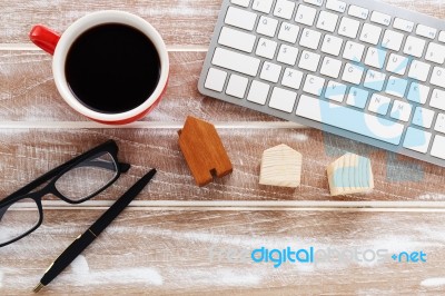 Computer Keyboard With House Model On Wood Background Stock Photo