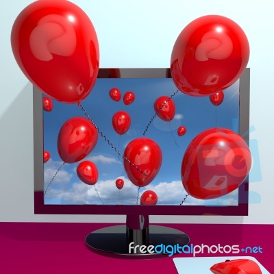 Computer with flying red balloons Stock Image