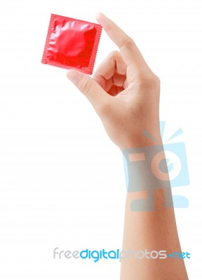 Condom In Female Hand Isolated On  White With Clipping Path Stock Photo