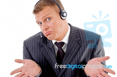 Confused Businessman Posing With Headset Stock Photo