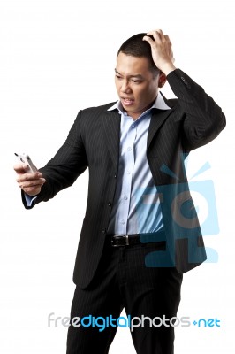 Confused Man Using Mobile Stock Photo