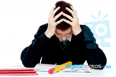 Confused School Boy With Notebook Stock Photo