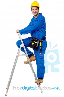 Construction Worker Climbing Up The Step Ladder Stock Photo