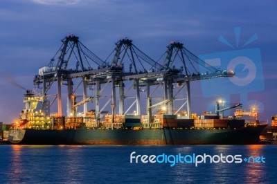 Containers Loading By Crane In The Twilight , Trade Port , Shipp… Stock Photo