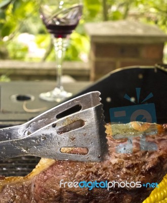 Cooking Steak On Barbecue Stock Photo