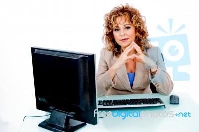 Corporate Feminine At Her Desk Stock Photo